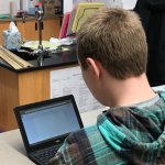 Seventh grade student using a Chromebook