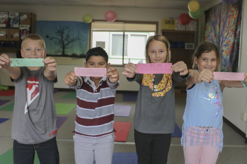 Captain Strong Primary School third graders hold up the anti-bullying bookmarks