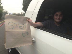 6th grader picking up supplies