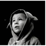 little boy looking up black and white photo