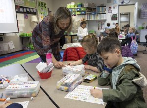 Captain Strong kindergarten teacher Diana Knauss helps a student