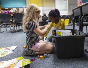 Two students working to build a project with LEGOs