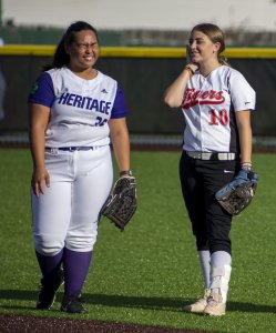 Two softball players laughing together
